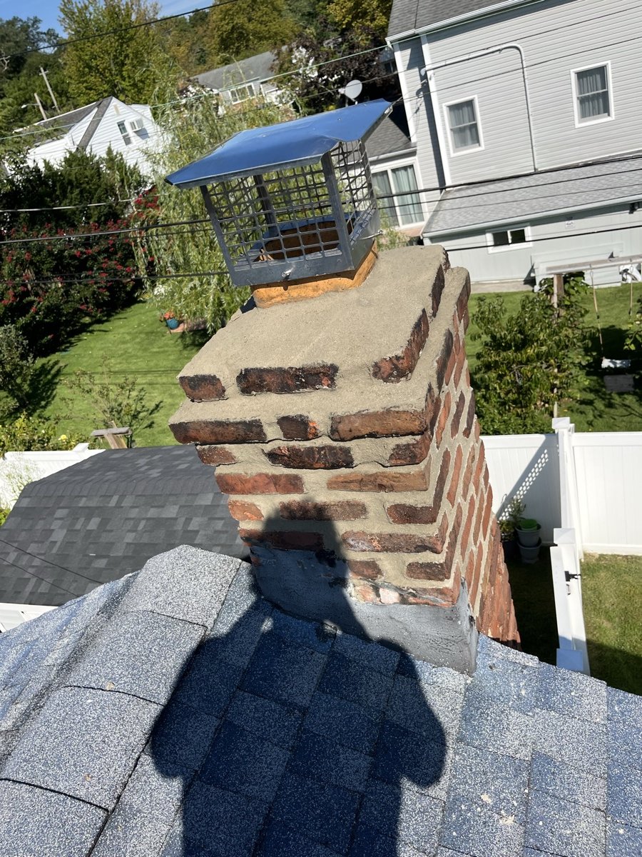 Rebuilt chimney with new concrete crown and stainless steel cap installed