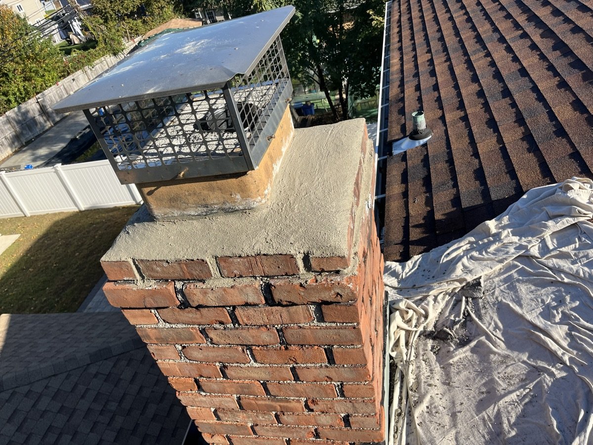 Completed chimney crown repair with new cap and fresh mortar on Long Island