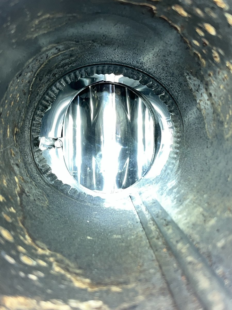 Looking down chimney flue showing new stainless steel liner installation