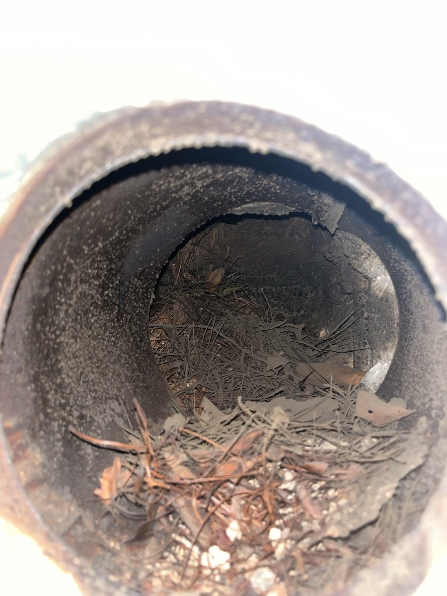 Inside view of chimney flue with new stainless steel liner looking up toward daylight