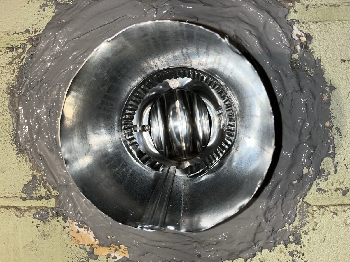 Blocked chimney flue with bird nest and debris requiring cleaning